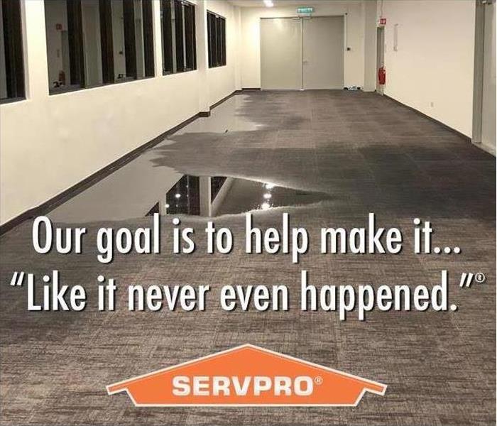 A hallway with wet carpet that says Our goal is to help make it "Like it never even happened." SERVPRO