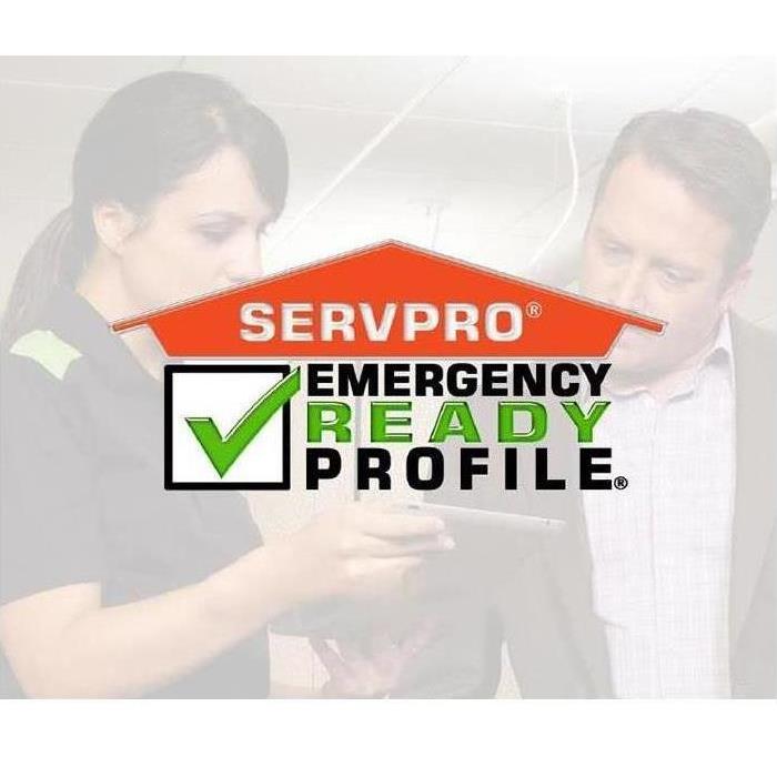 A man and a woman looking a cell phone- says SERVPRO Emergency Ready Profile