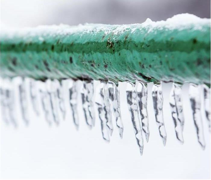 A frozen pipe with icicles hanging down