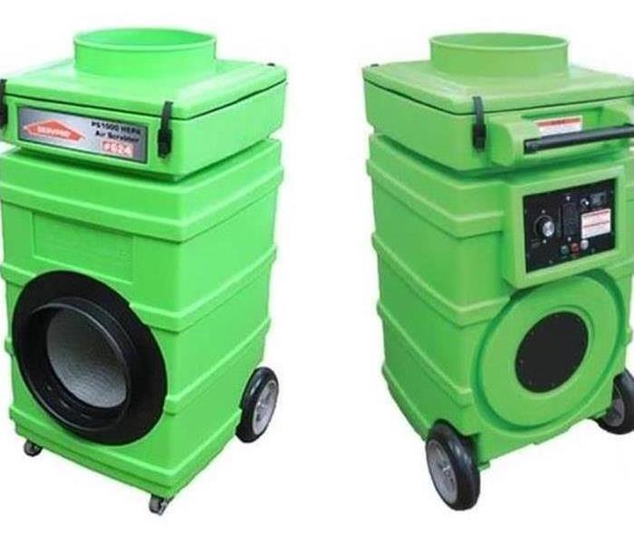 Two green air scrubbers that are used to remove odors. 